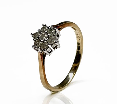Lot 300 - A 9ct gold ring set a diamond daisy cluster...