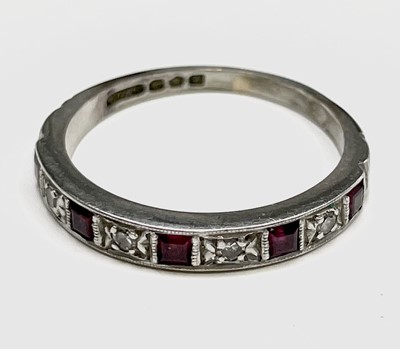 Lot 307 - A platinum ring hoop set with 5 rubies and 4...