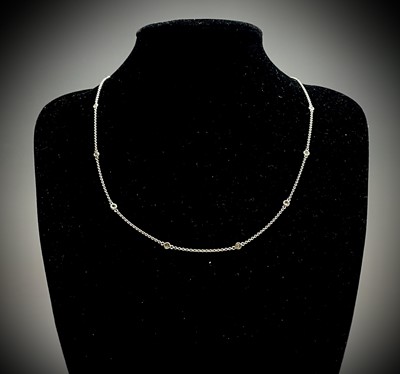 Lot 321 - An 18ct white gold 48cm chain spaced with 12...