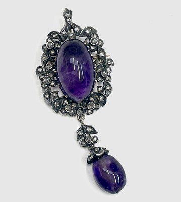 Lot 325 - A cabochon amethyst and diamond pendant/brooch...