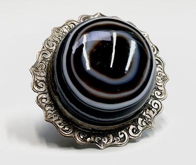 Lot 378 - A Victorian chased silver banded agate brooch...