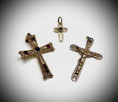 Lot 403 - An 18ct gold garnet set cross, a tiny 18ct...