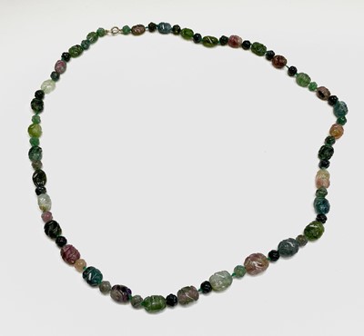 Lot 476 - A Chinese necklace of 33 carved tourmaline...