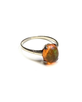 Lot 435 - A platinum ring set with a fire opal of...