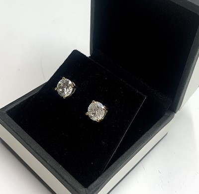 Lot 438 - A pair of diamond earring studs each of about...