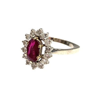Lot 450 - An 18ct white gold ring set an oval ruby of...