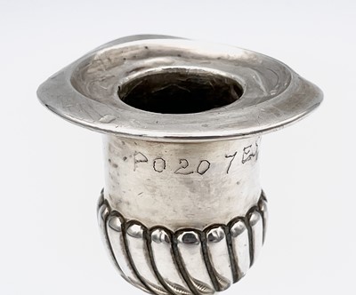 Lot 144B - A filled-silver candlestick and a small...