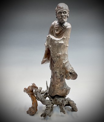 Lot 114 - A Chinese carved rootwood figure of a man in a...
