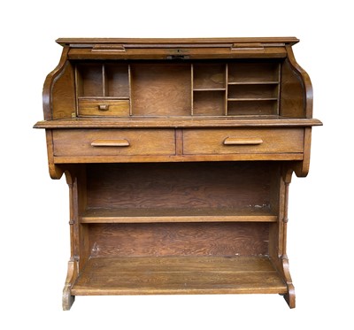 Lot 3196 - An early 20th century oak roll top desk, with...