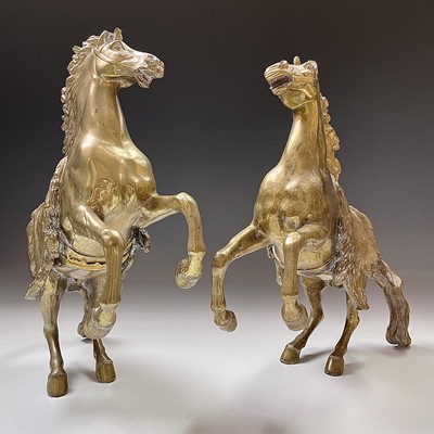 Lot 79 - A pair of brass rearing horse ornaments in the...