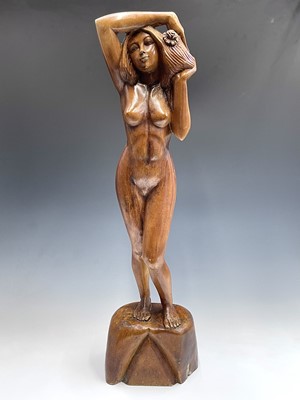 Lot 229 - A carved wooden figure of a standing female...