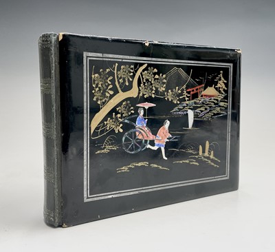 Lot 30 - A black Japanned photograph album depicting...