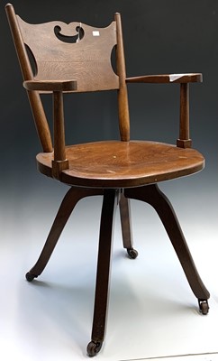 Lot 3197 - An Arts and Crafts style oak office swivel...