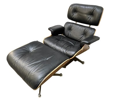 Lot 3253 - A Charles Eames style lounge chair and ottoman...
