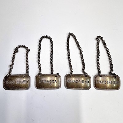 Lot 57 - A set of four pierced silver wine labels by...