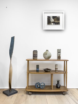 Lot 294 - An Ercol pale elm three tier bookcase trolley,...