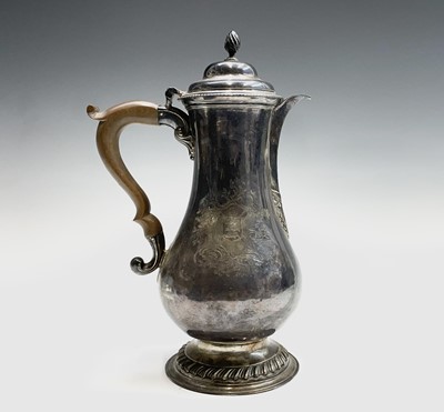 Lot 128 - A George III silver armorial bellied jug by...