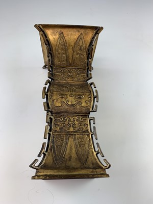 Lot 69 - A Chinese gilt bronze Gu-shaped vase, long...