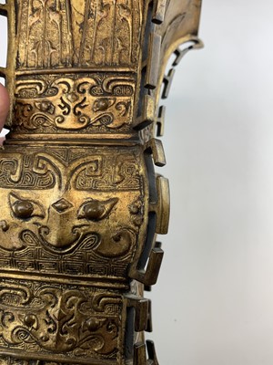 Lot 69 - A Chinese gilt bronze Gu-shaped vase, long...