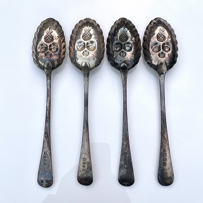 Lot 9 - Four George III silver berry spoons, each with...