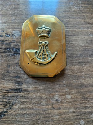 Lot 5 - A military brass plate, decorated with a crown...