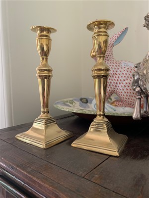 Lot 16 - A pair of Georgian brass candlesticks.