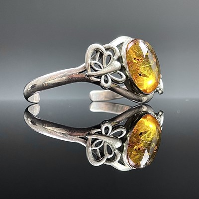 Lot 622 - A modern 925 silver amber set bangle, weight...