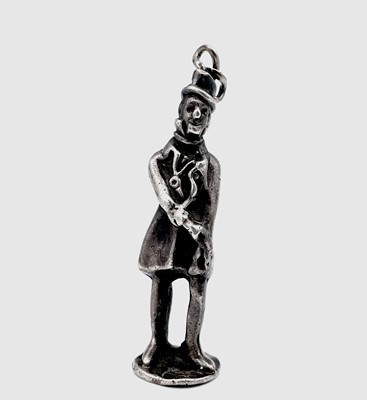Lot 234 - A silver pipe tamper modelled as a standing...
