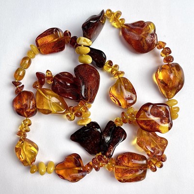 Lot 715 - A raw amber bead necklace, with irregular...