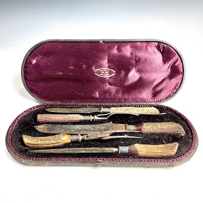 Lot 45 - A Victorian cased meat carving set with antler...