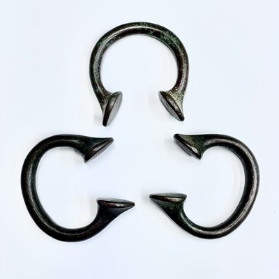 Lot 48 - Three bronze Manilla slave bangles.