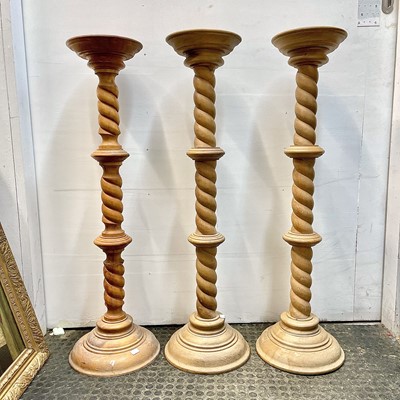 Lot 50 - A matched trio of large wood turned and carved...