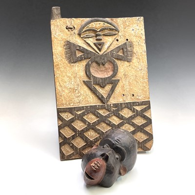 Lot 77 - An African wood carved panel of a stylised...