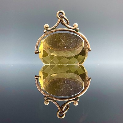 Lot 744 - A yellow metal mounted citrine swival fob,...