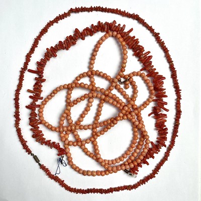 Lot 629 - A long coral bead necklace with gilt metal...