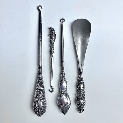 Lot 93 - Four dressing table implements with silver...