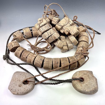 Lot 153 - Two strings of cork floats and stoneware end...