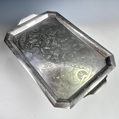 Lot 1003 - A Persian silver coloured twin-handled tray,...