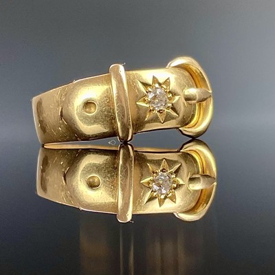 Lot 750 - An 18ct hallmarked gold buckle ring set with a...