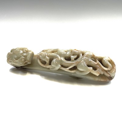 Lot 44 - A Chinese jade belt hook, Qing Dynasty, carved...