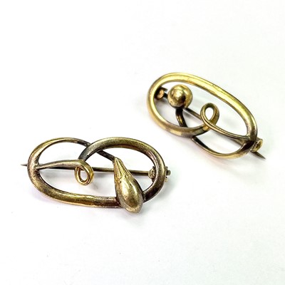 Lot 708 - A near pair of gold open work oval brooches,...