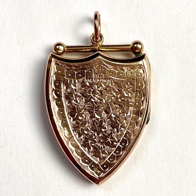 Lot 613 - A 9ct gold shield shaped foliate engraved...