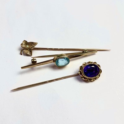 Lot 699 - Two gold tie pins, one set with an amethyst,...