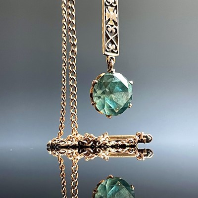 Lot 607 - A 9ct gold zircon set pendant necklace, the...