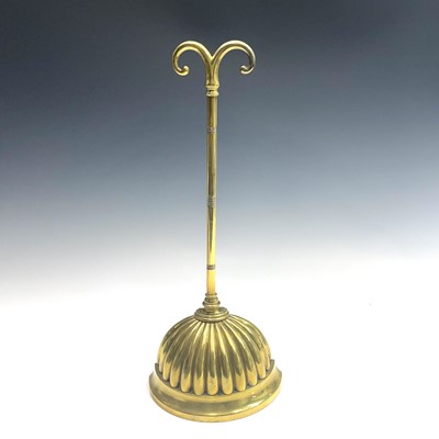 Lot 9 - A Regency brass and cast iron door porter,...