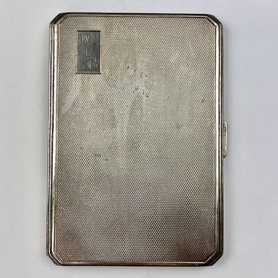 Lot 128 - A George VI silver engine turned cigarette...