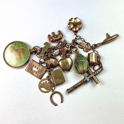 Lot 734 - A 9ct gold charm bracelet with 16 gold charms...