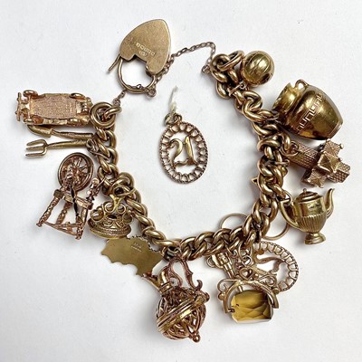 Lot 755 - A 9ct gold charm bracelet with 18 various...