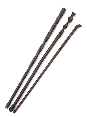 Lot 168 - A primitive chip carved hardwood walking stick,...