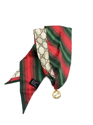Lot 1065 - Gucci silk choker Silk scarf choker in reds...